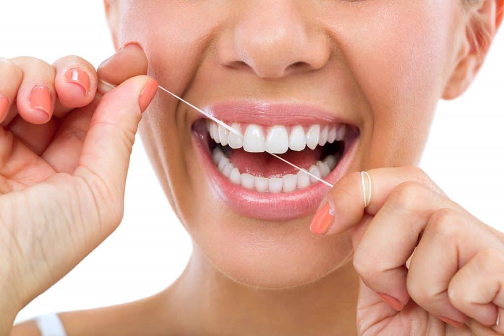 lady flossing teeth oral hygiene