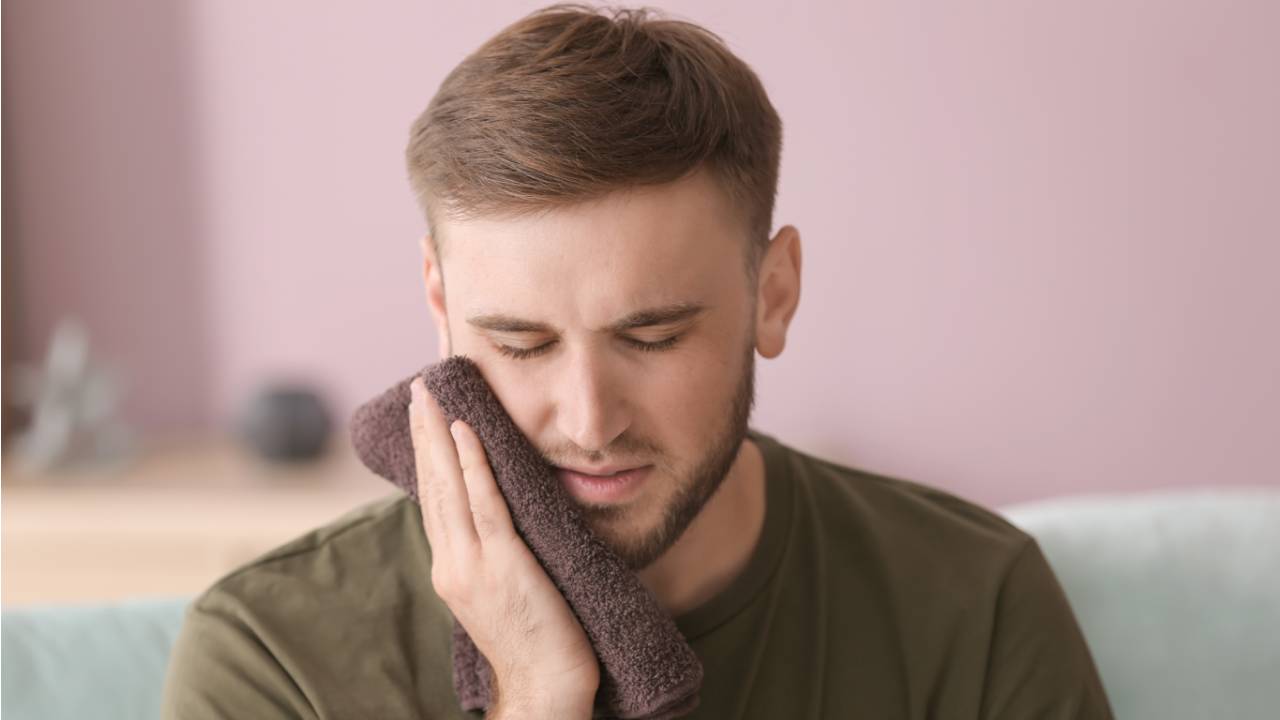 man suffering with toothpain