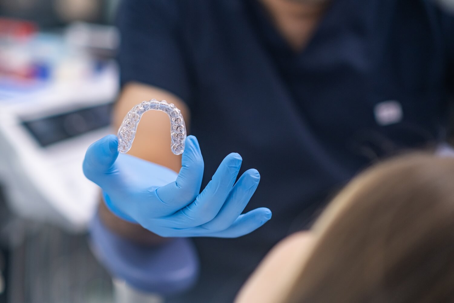 dentist showing an invisalign to a patient