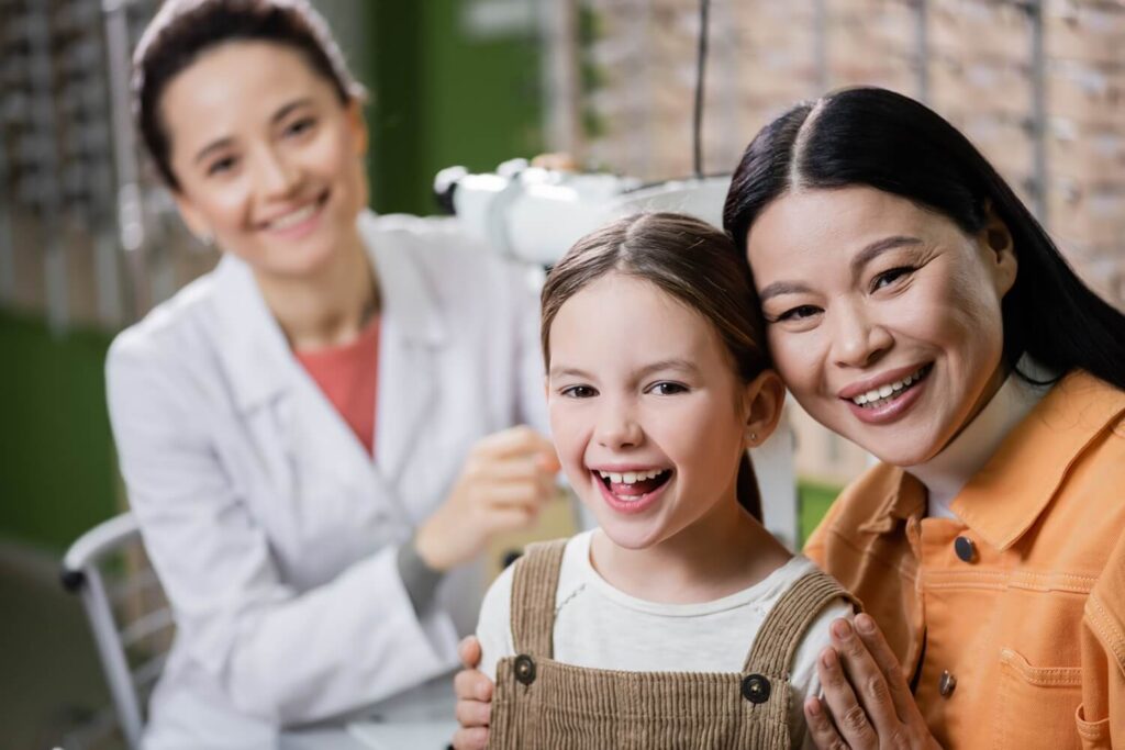 Dentist with child patient and mother, child dentistry