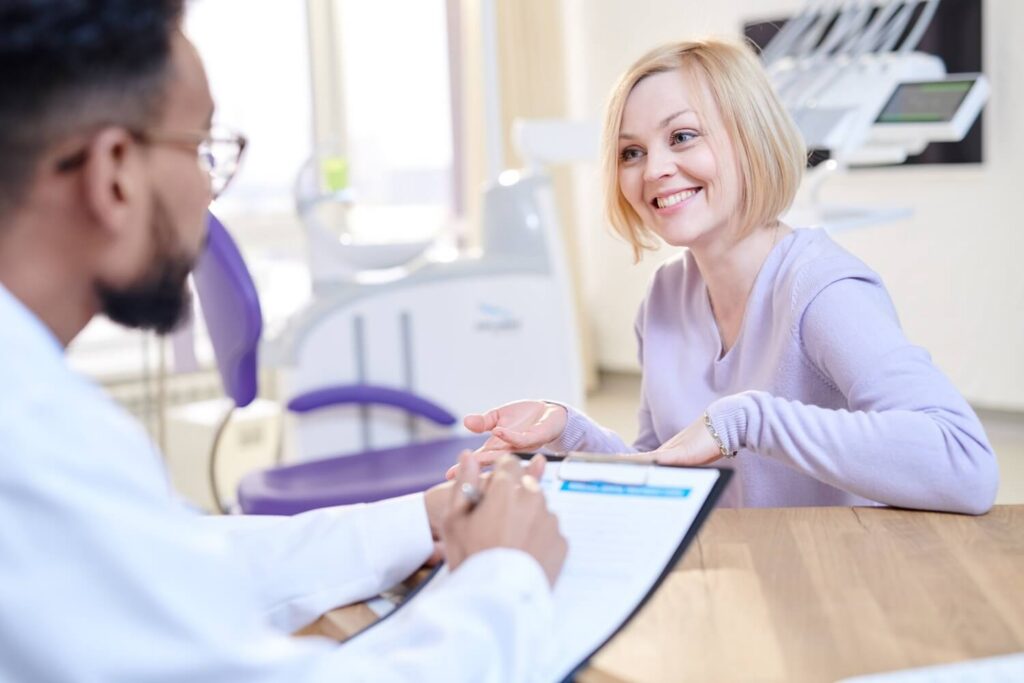 woman at the dentist talking about dental insurance